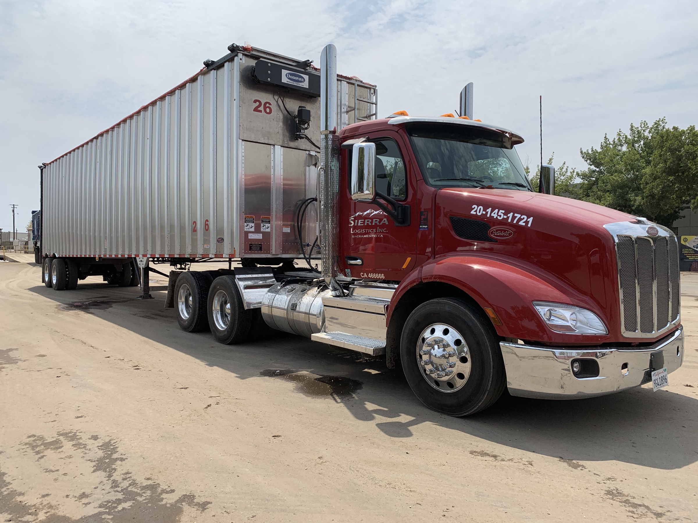 A Sierra Logistics truck and trailer parked in the company's yard in Sacramento, California.